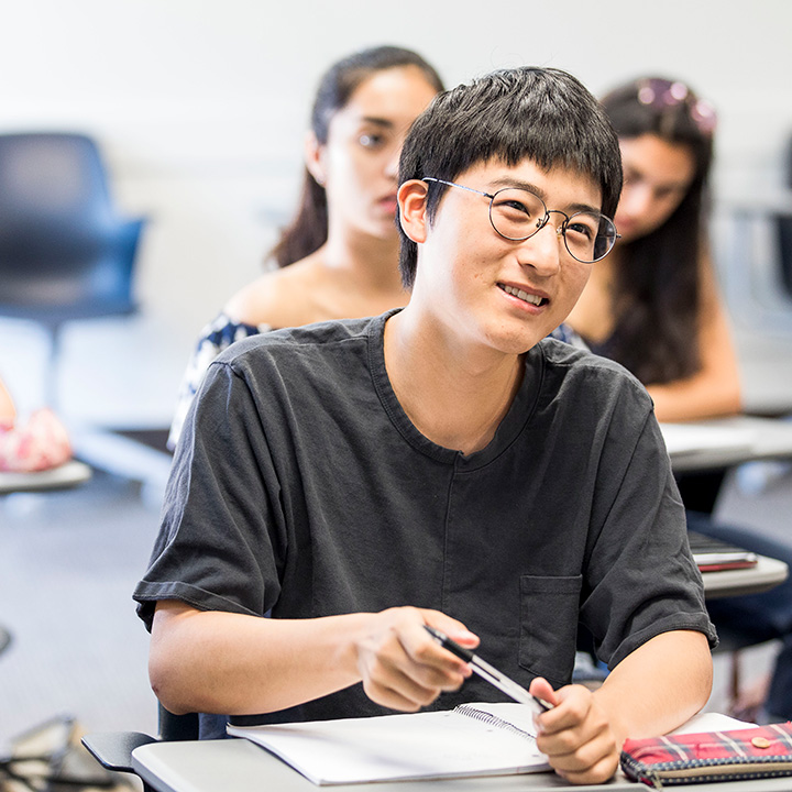 A student smiling in class